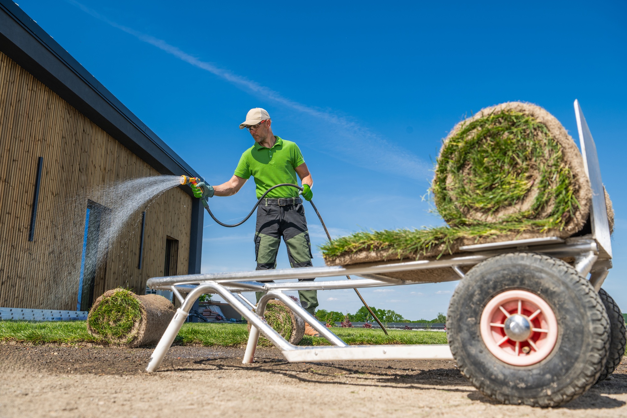 Garden Worker Installing Grass Turfs