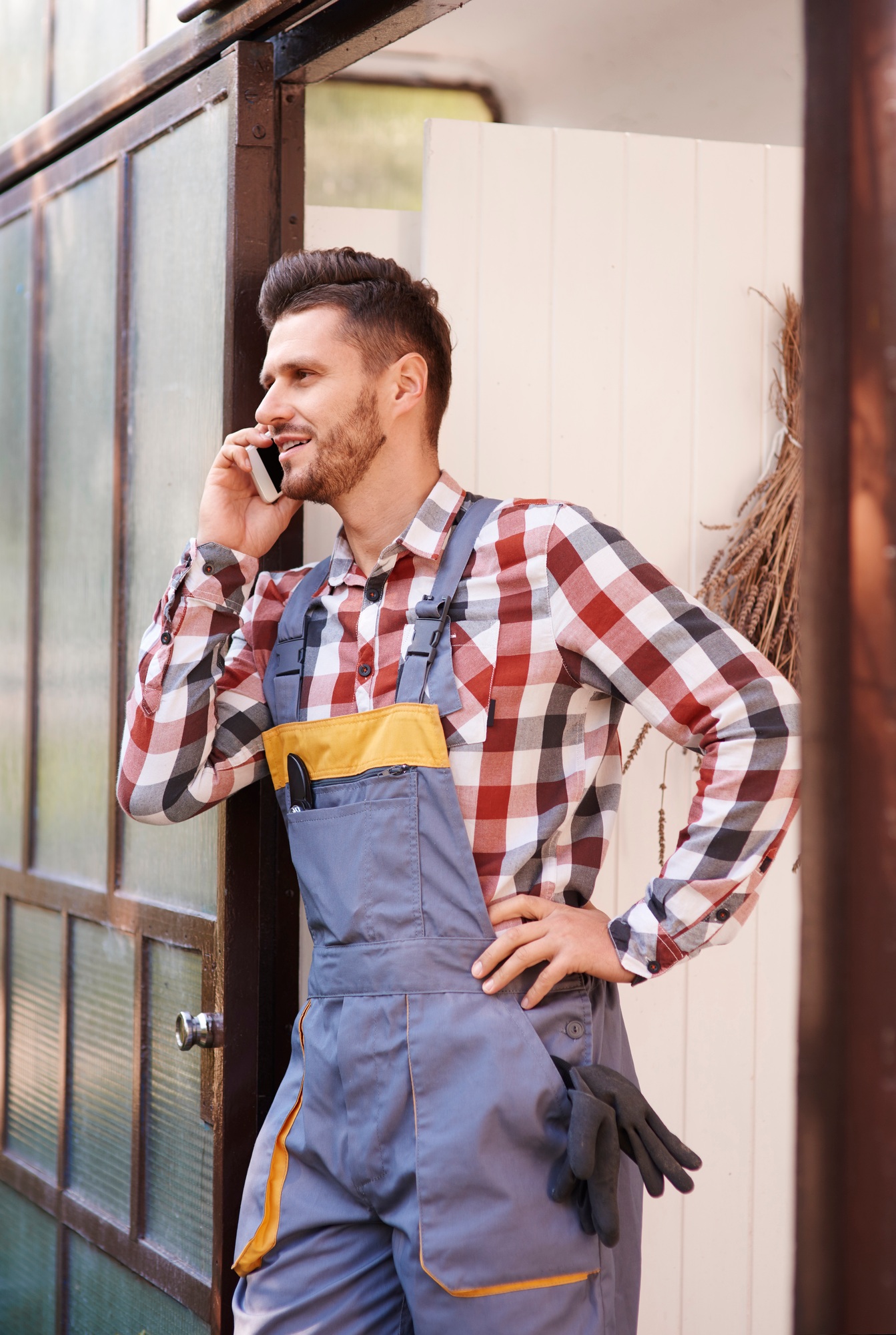 Gardener talking by mobile phone