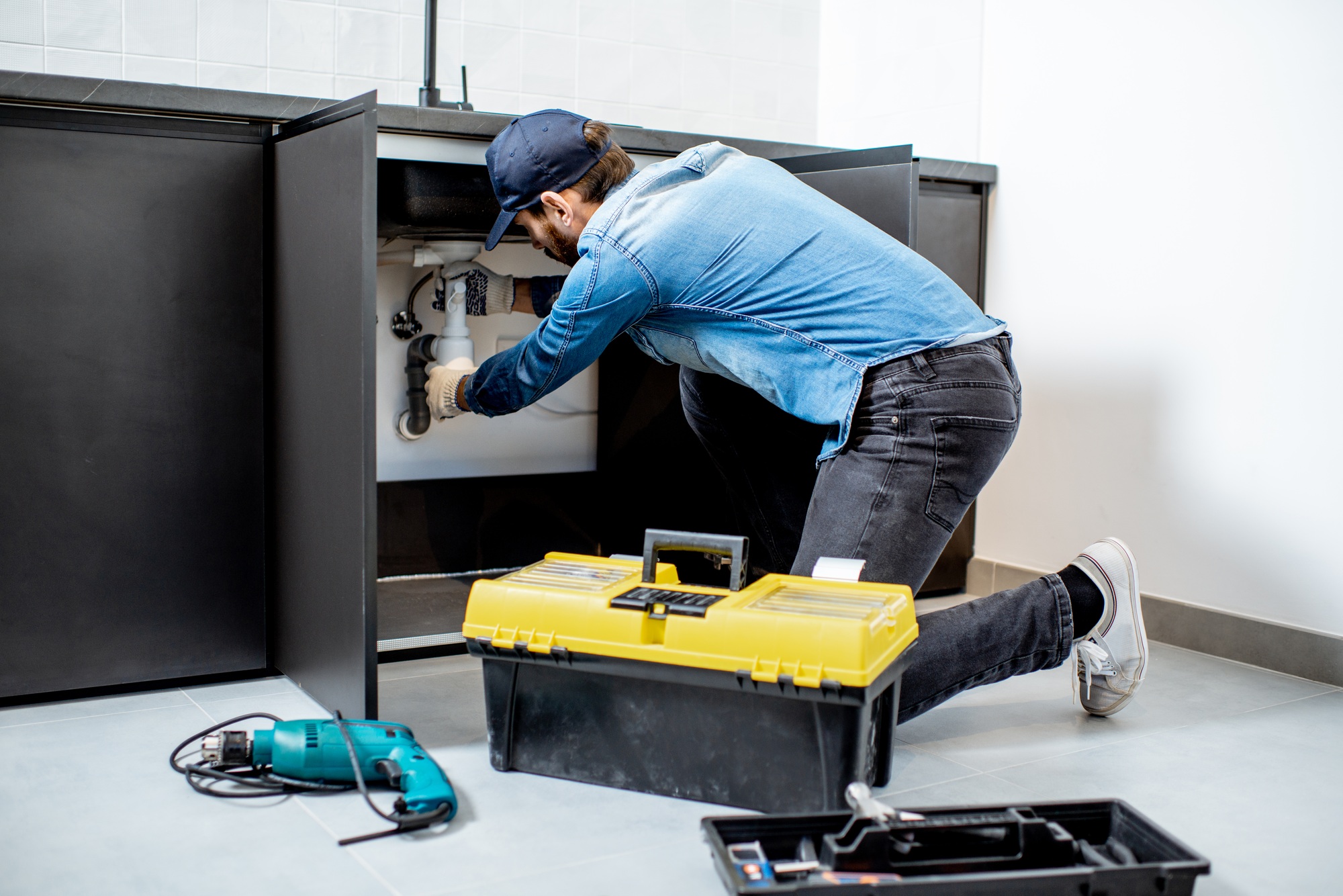 Man repairing kitchen furniture